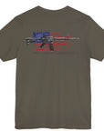 Army green color fabric patriotic shirt rear view has an americantees.us logo with eagle head on front , rear view has distressed American flag with modern sporting rifle with the log Pro Armis Libertas meaning For Arms, Freedom