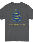 rear view of a asphalt colored fabric shirt with americantees.us logo on front and a Gadsden flag on the back