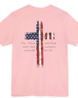 rear view of a pink colored fabric patriotic shirt with americantees.us logo on front and American flag in shape of a Christian cross with pledge of allegiance surrounding image on back