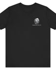 Front view of a black colored t-shirt with a graphic design of a rifle crossed with a quill fountain pen and an American flag ribbon, with the quote Defend the Republic by law or by force. Patriotic Shirts. logo design on front.