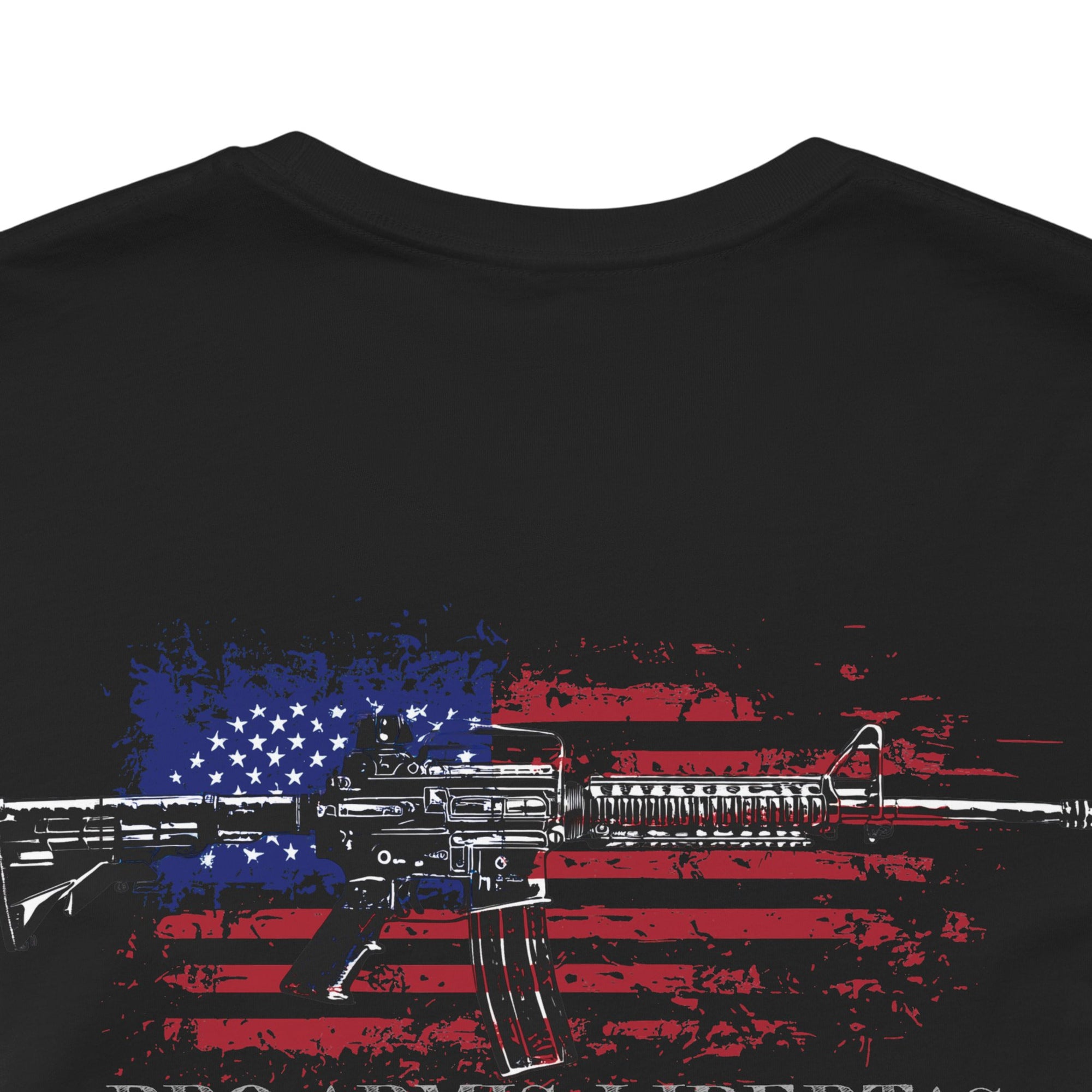 Black color fabric patriotic shirt closeup view has an americantees.us logo with eagle head on front , rear view has distressed American flag with modern sporting rifle with the log Pro Armis Libertas meaning For Arms, Freedom