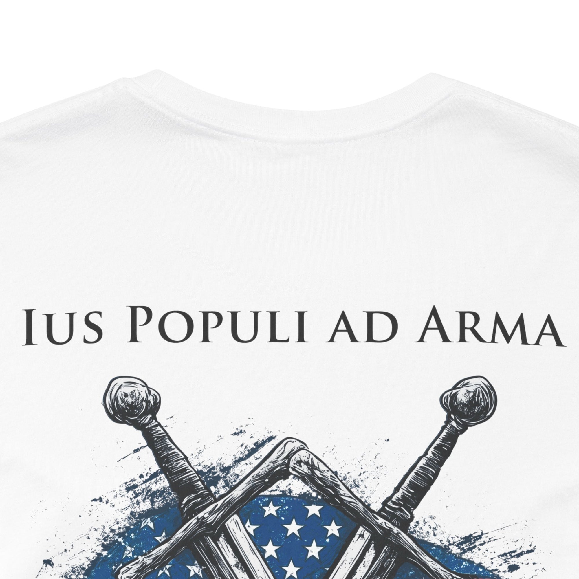 white colored t-shirt featuring two crossed swords in front of a full-color American flag graphic, with the text "Ius Populi ad Arma" in bold black font above. back view closeup