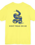 rear view of a yellow colored fabric shirt with americantees.us logo on front and a Gadsden flag on the back