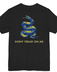 rear view of a black colored fabric shirt with americantees.us logo on front and a Gadsden flag on the back
