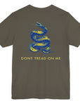 rear view of a army green colored fabric shirt with americantees.us logo on front and a Gadsden flag on the back