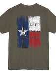 rear view of army green colored fabric shirt with americantees.us logo on front and Texas flag with rifle and Keep Texas Free writing on back