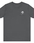 Front view of an asphalt colored t-shirt with a graphic design of a rifle crossed with a quill fountain pen and an American flag ribbon, with the quote Defend the Republic by law or by force. Patriotic Shirts. logo design on front.