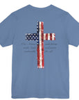 rear view of a lavender blue colored fabric patriotic shirt with americantees.us logo on front and American flag in shape of a Christian cross with pledge of allegiance surrounding image on back