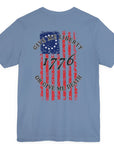 rear view of a steel blue colored fabric shirt with americantees.us logo on front and betsy ross flag with the phrase give me liberty or give me death and 1776 on the back