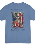 rear view of patriotic shirt lavender blue color fabric tee with logo on front and american flag with liberty bell and crossed rifles on back, motto that states Come and Take Them and molon labe on scroll