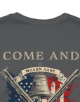 rear view close up of patriotic shirt asphalt color fabric tee with logo on front and american flag with liberty bell and crossed rifles on back, motto that states Come and Take Them and molon labe on scroll