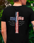 rear view of a man wearing a black colored fabric patriotic shirt with American flag in shape of a Christian cross with pledge of allegiance surrounding image