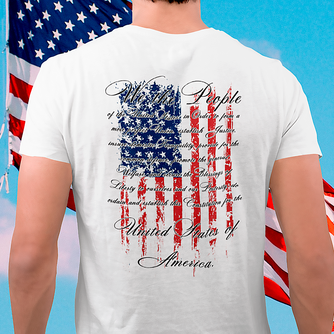 rear view of a man wearing white colored fabric patriotic shirt in front of flag with American flag background and the preamble of the united states constitution on the back pf shirt, front of shirt has americantees.us logo