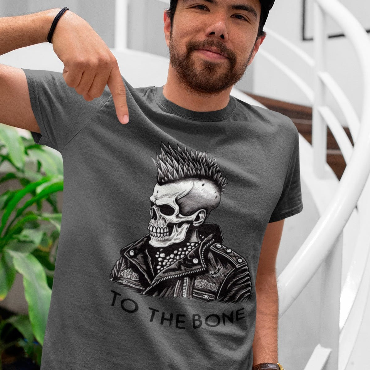 punk-to-the-bone-asphalt-t-shirt--mockup-of-a-happy-customer-with-a-cap-at-the-end-of-a-staircase