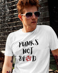 punks-not-dead-anarchy-sign-white-t-shirt-mockup-of-a-red-haired-man-posing-next-to-a-fountain