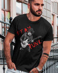 stay-punk-with-punk-rocker-guitarist-black-t-shirt-mockup-of-a-serious-looking-man-standing-on-concrete-steps