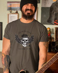 too-weird-to-live-too-rare-to-die-army-t-shirt-with-skull-and-wings-mockup-of-a-man-with-his-electric-guitar-at-home-alt