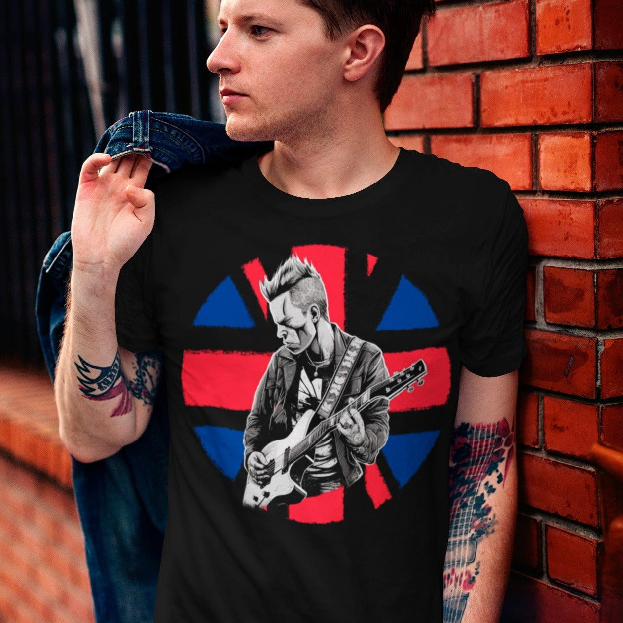 union-jack-black-punk-t-shirt-mockup-featuring-a-stylish-man-leaning-on-a-brick-wall