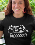 Mooooody-cow-farm-black-t-shirt-funny-mockup-of-a-happy-middle-aged-woman-wearing-a-tee-while-having-a-coffee-in-the-backyard