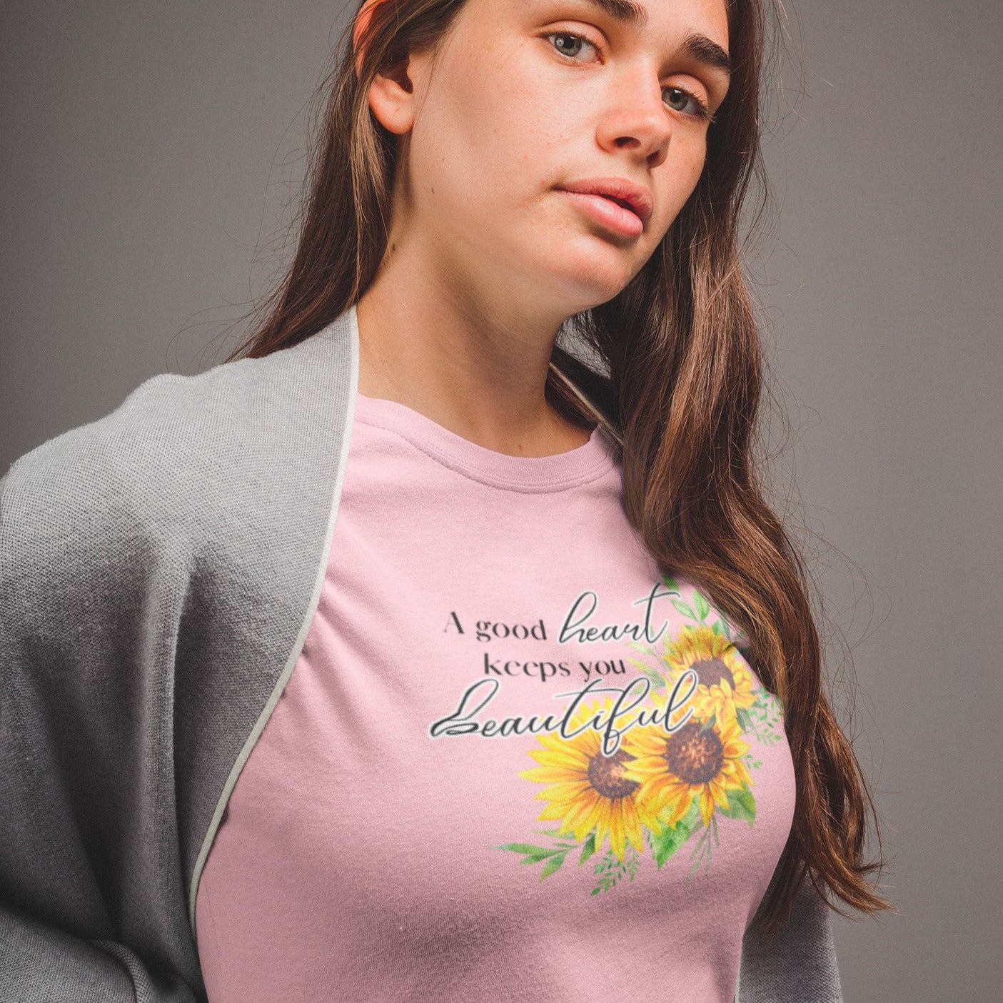 a-good-heart-keeps-you-beautiful-pink-t-shirt-womens-sunflower-mockup-of-a-pretty-woman-in-a-grey-room