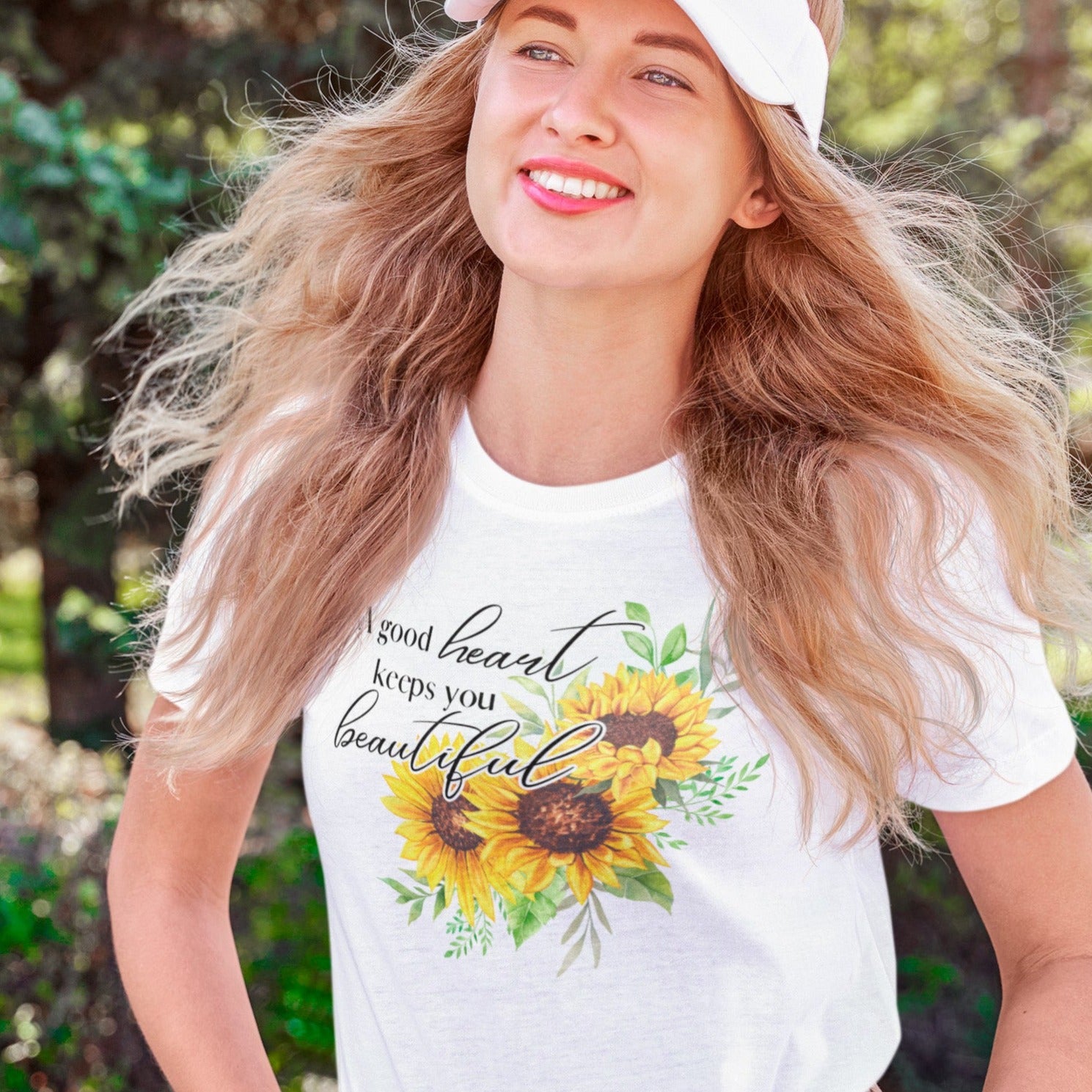 a-good-heart-keeps-you-beautiful-white-t-shirt-womens-sunflower-mockup-of-a-happy-young-woman-strolling-at-a-park