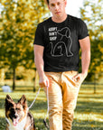 adopt-dont-shop-black-t-shirt-with-dog-graphic-unisex-mockup-of-a-man-walking-his-dog-at-a-park