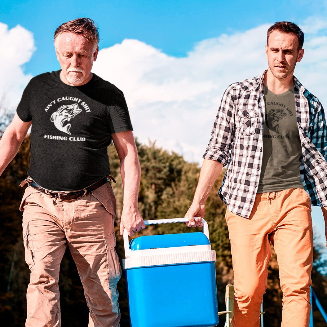 aint-caught-shit-fishing-club-black-and-army-green-t-shirt-mens-sports-mockup-of-two-fishermen-carrying-their-cool-box