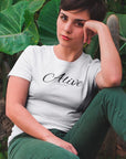 alive-out-of-spite-white-t-shirt-funny-mockup-of-a-girl-relaxing-near-cactus-and-plants-wearing-a-tee