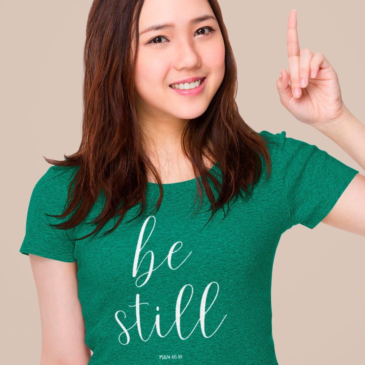 be-still-psalm-46-10-heather-kelly-green-t-shirt-womens-christian-inspiring-mockup-featuring-a-young-woman-pointing-her-finger-up
