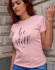 be-still-psalm-46-10-pink-t-shirt-womens-christian-inspiring-mockup-of-a-woman-with-long-hair-leaning-on-a-brick-wall