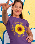 be-true-be-you-be-kind-be-brave-team-purple-t-shirt-sunflower-womens-shirt-mockup-of-a-woman-doing-the-peace-sign-against-a-street-art-wall