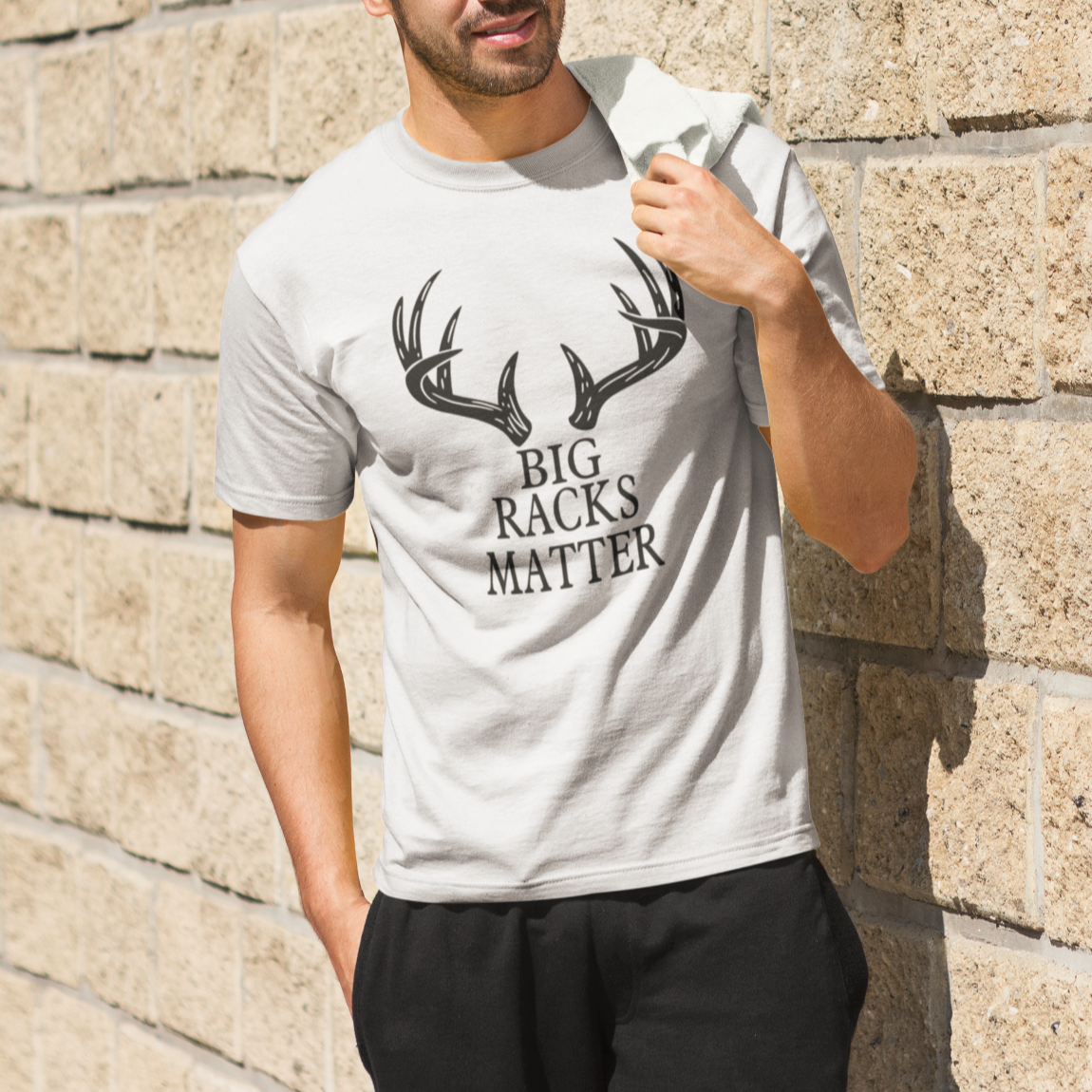 big-racks-matters-white-t-shirt-hunting-young-man-standing-next-to-a-brick-wall