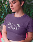book-nerd-with-glasses-graphic-team-purple-t-shirt-womens-reading-mockup-of-a-girl-with-short-hair-wearing-a-round-neck-tee