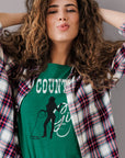 country-girl-with-lasso-heather-kelly-green-t-shirt-cowgirl-mockup-of-a-woman-grabbing-her-hair-in-a-studio