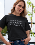created-with-a-purpose-black-t-shirt-mockup-of-a-girl-with-a-coy-smile-by-a-balcony