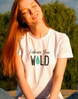 embrace-your-wild-with-tree-graphic-soft-cream-t-shirt-womens-outdoors-mockup-of-a-woman-enjoying-nature
