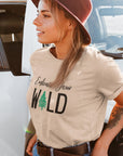 embrace-your-wild-with-tree-graphic-soft-cream-t-shirt-womens-outdoorsmockup-featuring-a-stylish-woman-with-a-tattoo