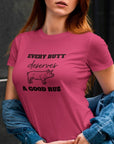 every-butt-deserves-a-good-rub-berry-t-shirt-with-pig-graphic-barbeque-cooking-unisex-mockup-of-a-woman-wearing-a-customizable-crewneck-tee-by-a-dark-wall