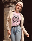 first-of-all-no-second-of-all-no-pink-t-shirt-sarcastic-women-mockup-of-a-girl-wearing-a-t-shirt-and-a-trench-coat-outside-a-stone-church