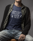 fishing-solves-most-of-my-problems-hunting-solves-the-rest-navy-bella-canvas-t-shirt-mockup-featuring-a-serious-man-sitting-on-a-stool