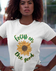 focus-on-the-good-sunflower-white-t-shirt-womens-young-woman-with-her-hands-on-her-waist-standing-outdoors-while-wearing-a-tee