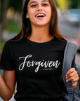 forgiven-luke-5-20-black-t-shirt-unisex-inspiring-christian-tee-mockup-of-a-young-female-student-laughing