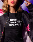 gettin-piggy-with-it-black-t-shirt-funny-dancing-pigs-mockup-featuring-a-pretty-girl-posing-in-a-hipster-style