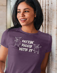 gettin-piggy-with-it-team-purple-t-shirt-funny-dancing-pigs-mockup-of-a-woman-wearing-a-t-shirt-and-leaning-against-a-granite-wall