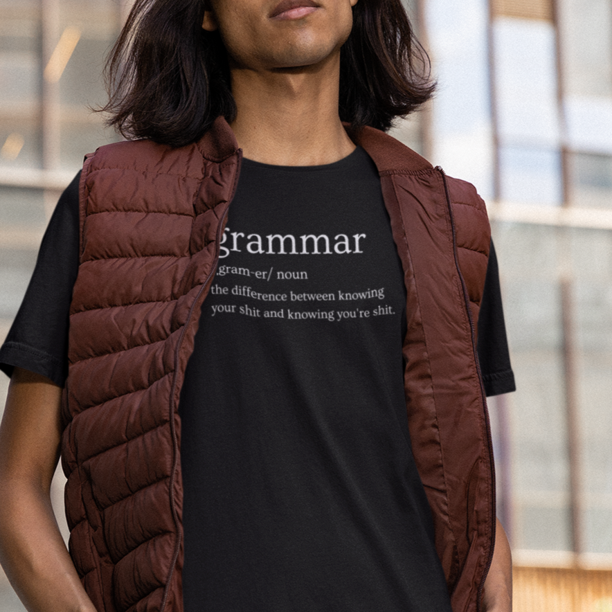 grammar-the-difference-between-knowing-your-shit-and-knowing-youre-shit-team-purple-t-shirt-bella-canvas-tee-mockup-of-a-man-with-long-hair-posing-on-a-street