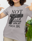 gun-girl-not-a-pepper-spray-kind-of-girl-athletic-heather-grey-t-shirt-mockup-featuring-a-woman-pointing-at-her-bella-canvas-tee
