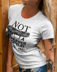 gun-girl-not-a-pepper-spray-kind-of-girl-white-t-shirtt-shirt-mockup-of-a-tattooed-woman-leaning-on-a-wooden-surface