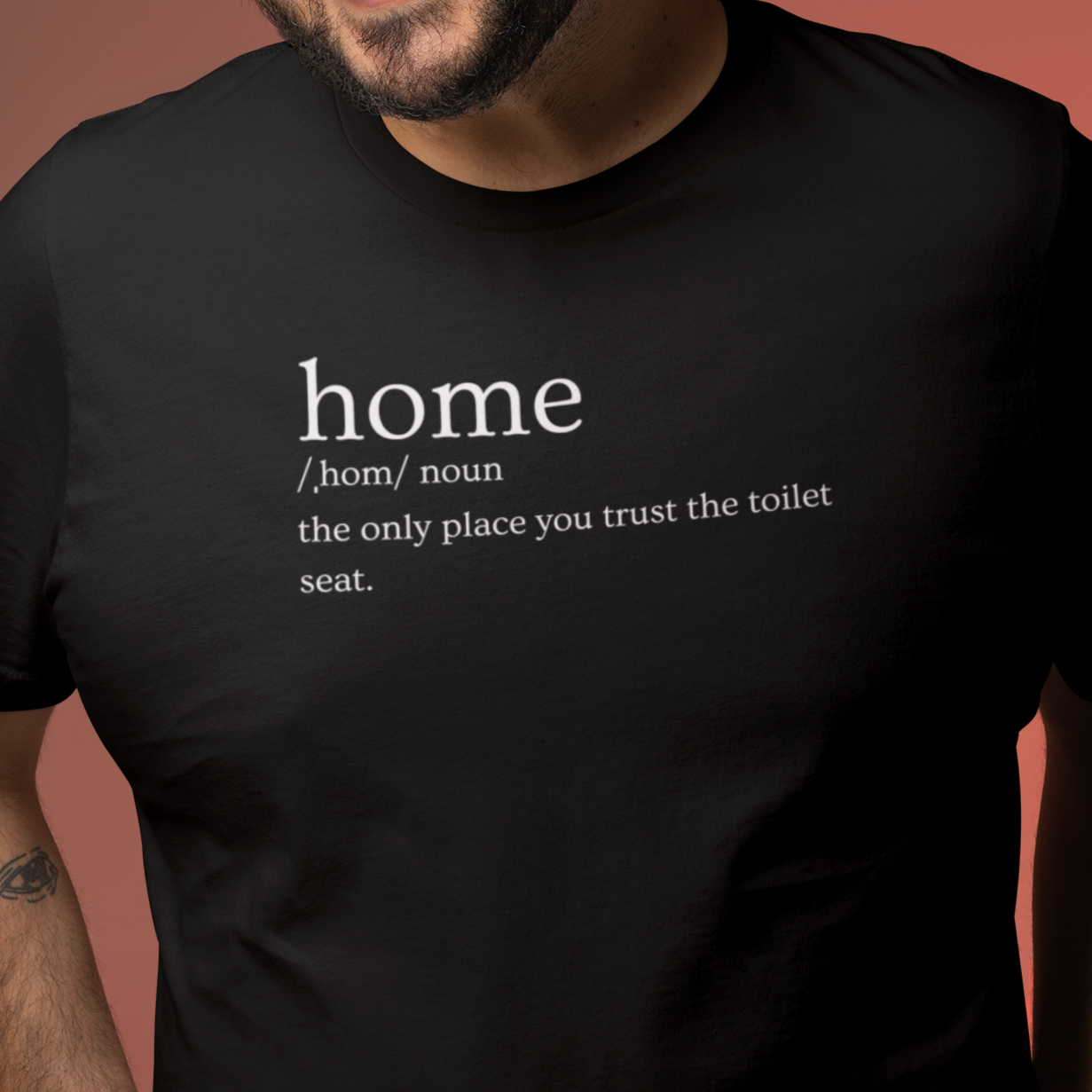 home-the-only-place-you-trust-the-toilet-seat-black-t-shirt-mockup-featuring-a-man-smiling-against-a-colorful-back-setting