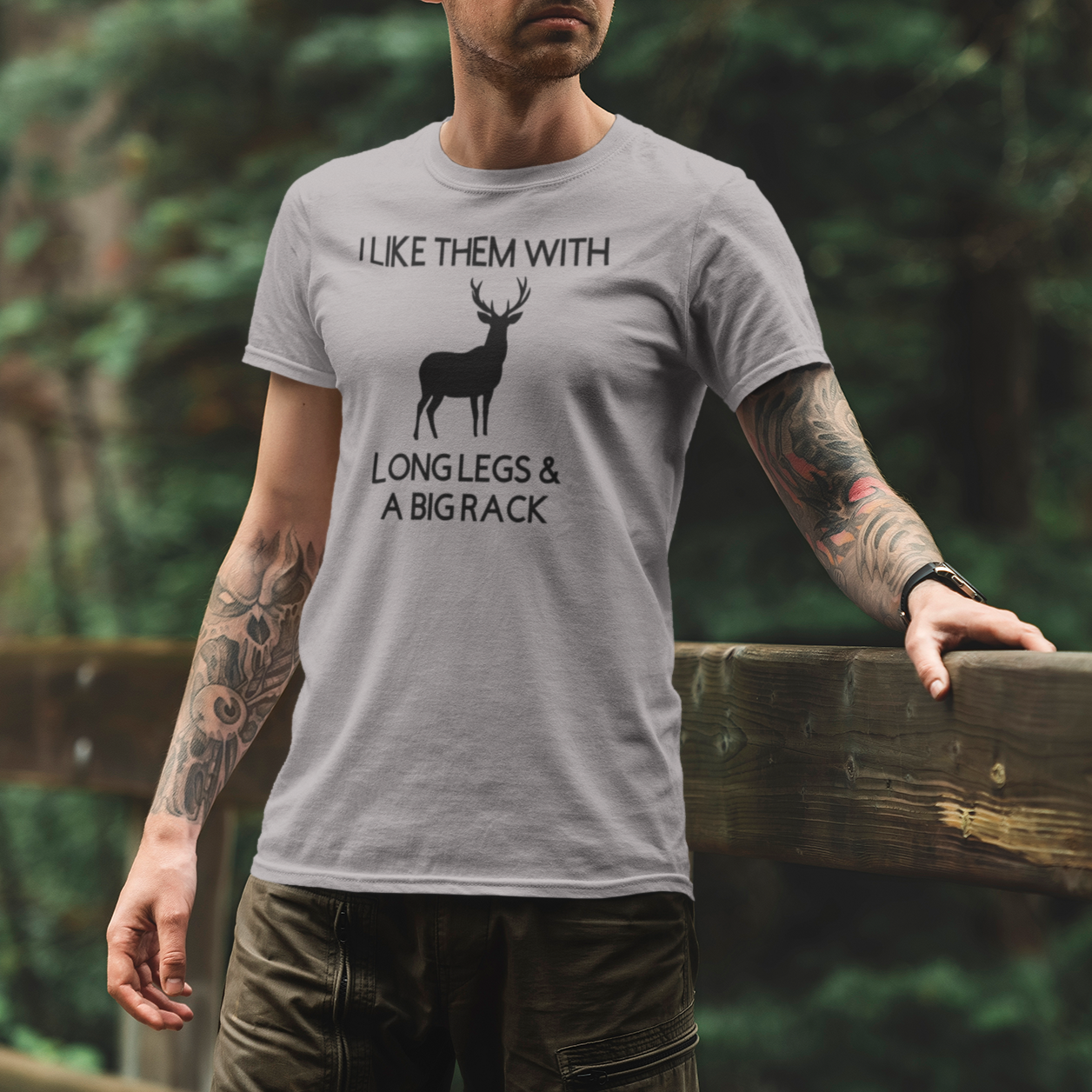 i-like-them-with-long-legs-and-a-big-rack-athletic-heather-grey-t-shirt-mockup-of-a-man-standing-on-a-bridge-at-a-national-park