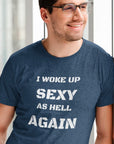 i-woke-up-sexy-as-hell-again-heather-navy-t-shirt-of-a-smiling-man-leaning-on-a-wall